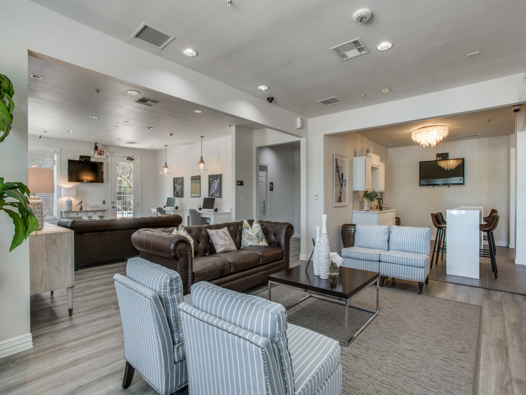 spacious community area with tvs, couches and restrooms